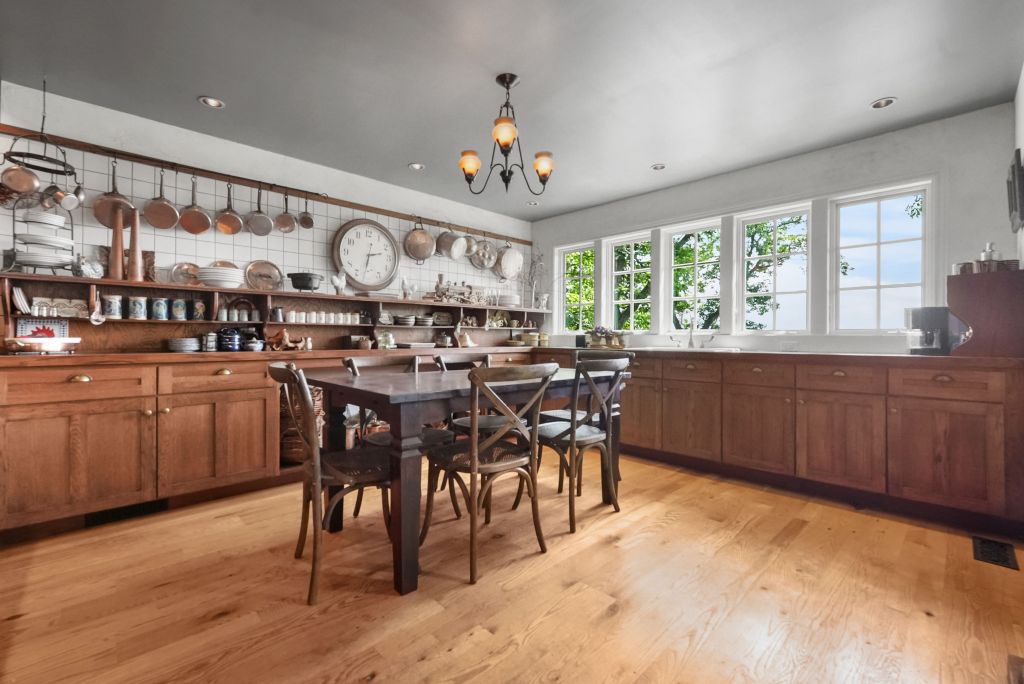 Farmhouse kitchen with wood cabinets and dining table